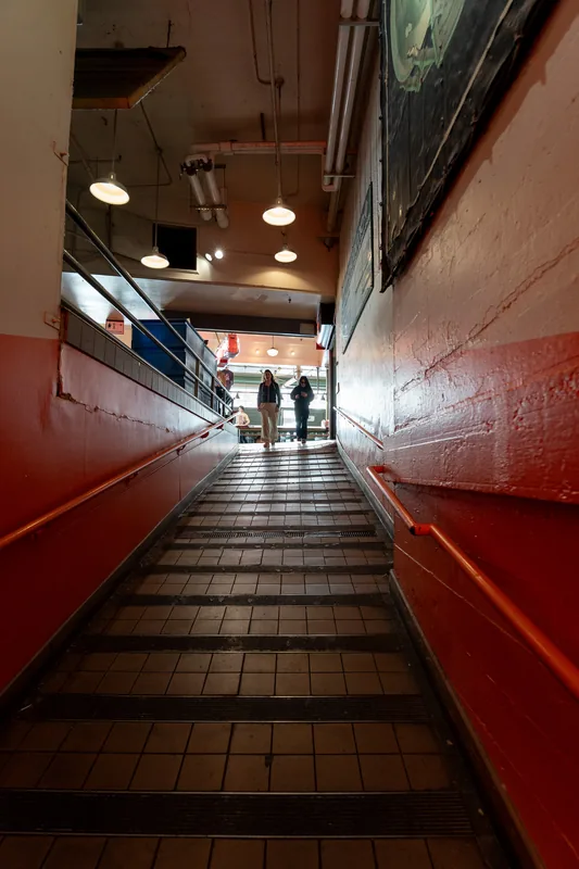 An indoor stairway between red walls.