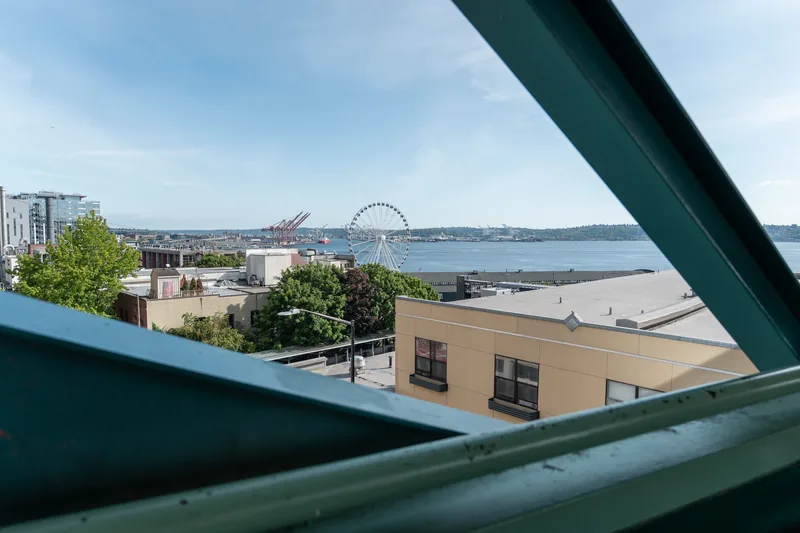 A harbor seen through diagonal green structural beams.