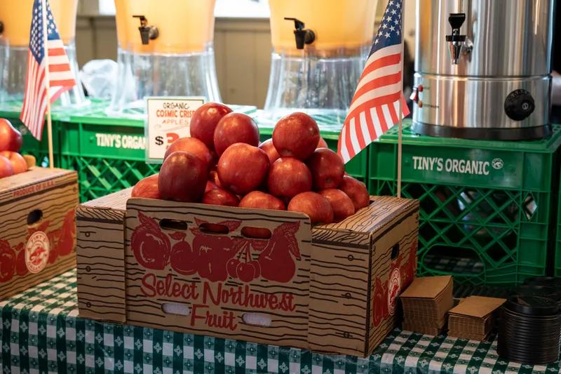 Crates of red tomatoes at a market stall.