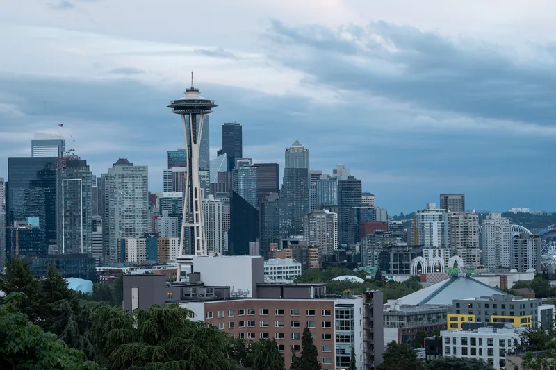 The Space Needle above a city skyline at dusk.